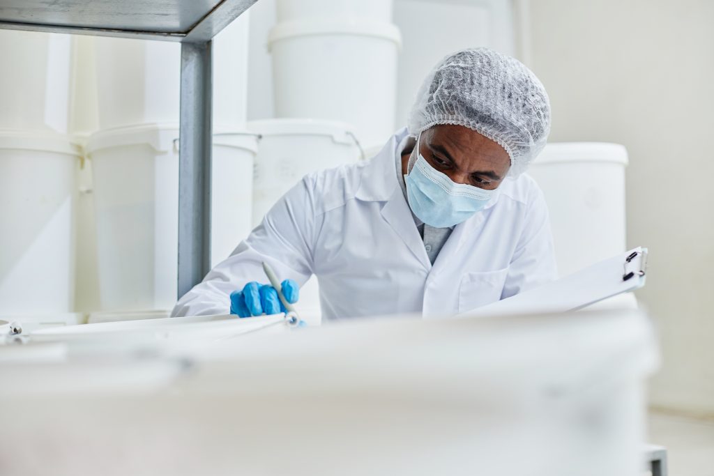 pharmaceutical employee ensuring risk management protocols are followed